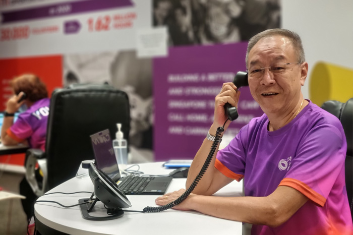 Keh Eng Song volunteers at SportSG COVID-19 call centre.